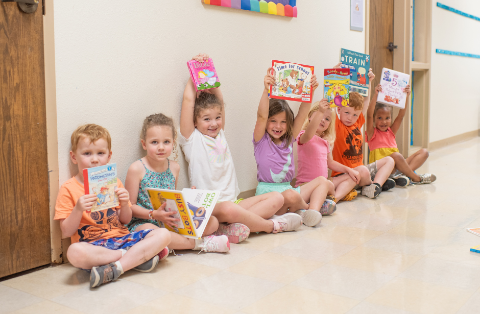 Holy Trinity ELC selective focal photo of crayons in yellow box